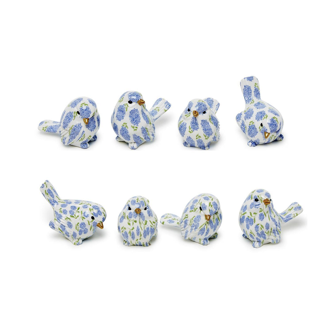 Set of eight small ceramic birds with floral patterns on a white background