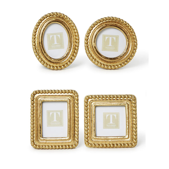 Four gold picture frames with a central letter 'T' on a white background