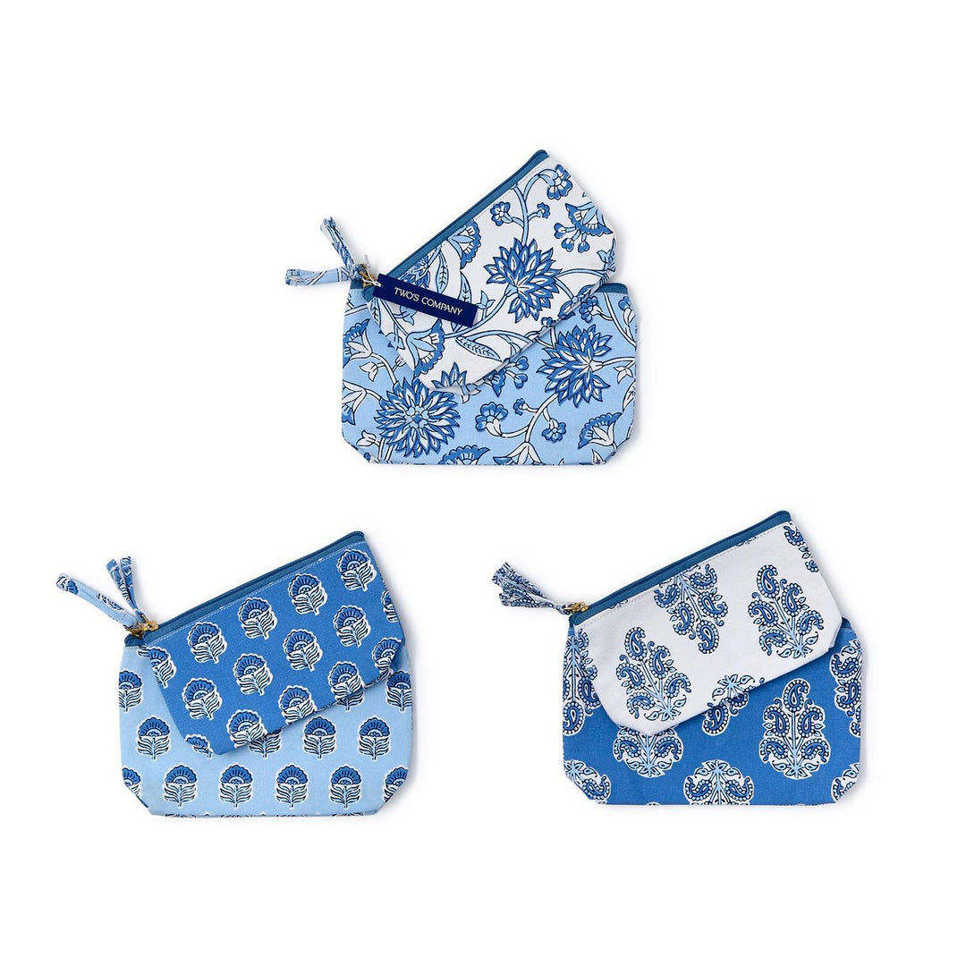 Set of three blue and white patterned pouches on a white background