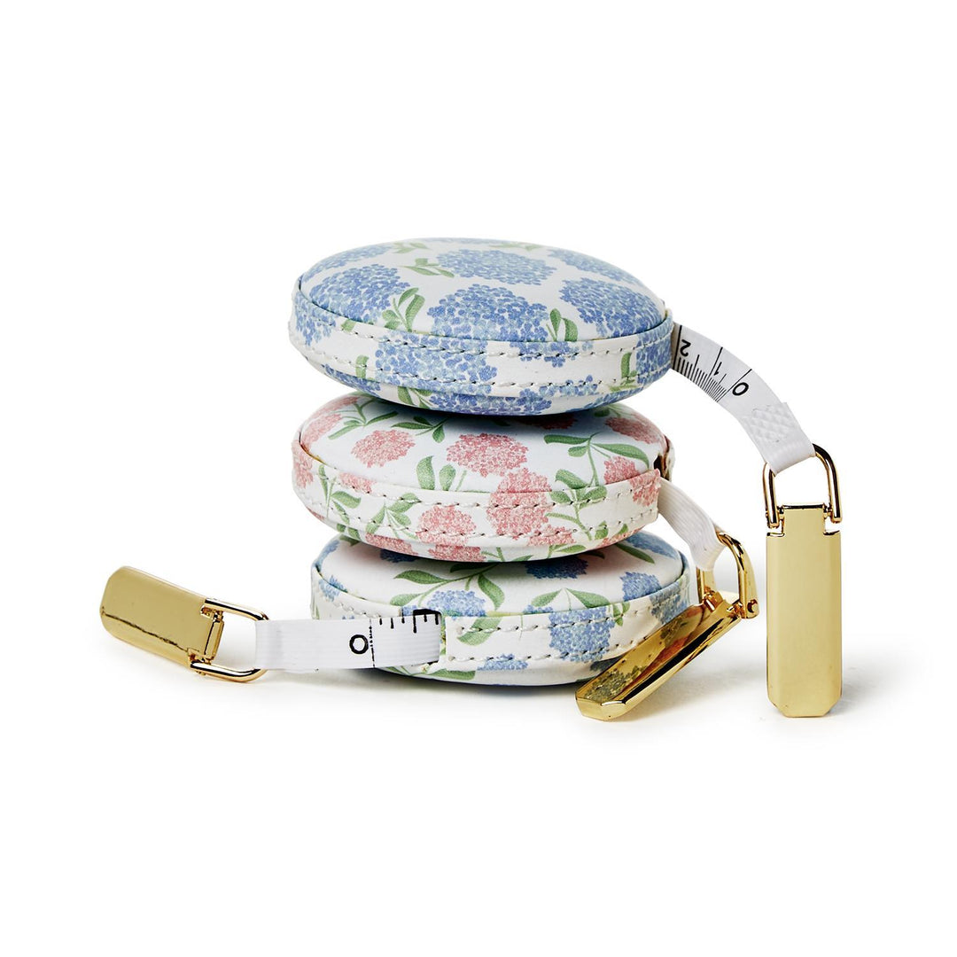 Retractable measuring tape with floral design on a white background