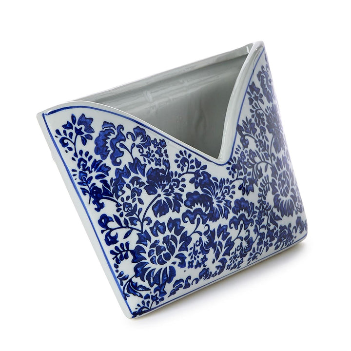 Triangular ceramic planter with blue floral pattern on a white background