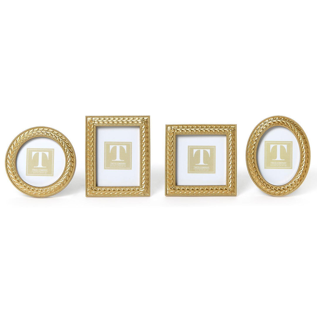 Set of four gold picture frames with 'T' monogram on a white background