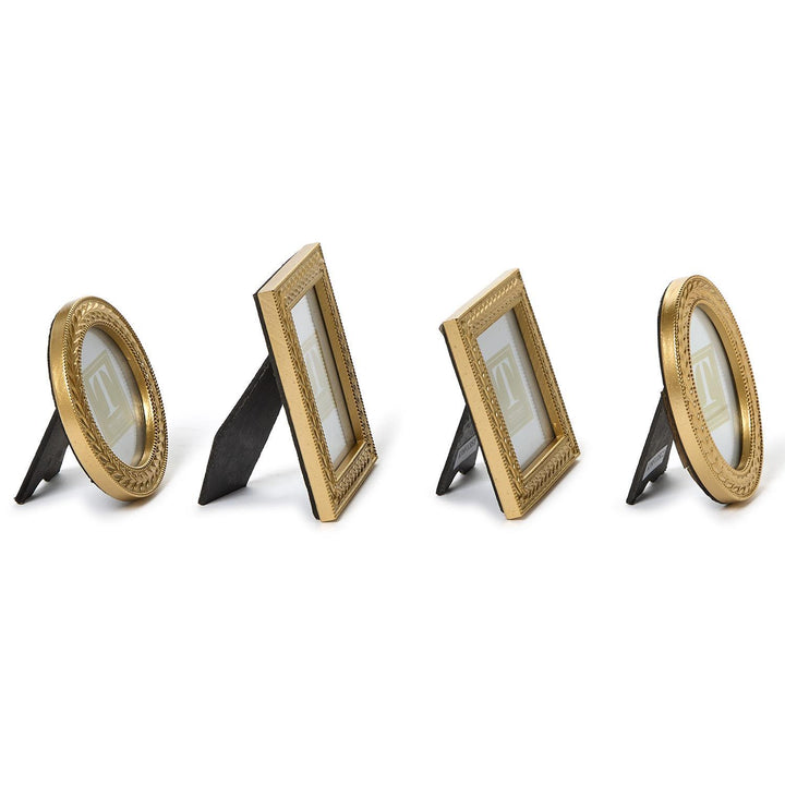 Set of four gold photo frames on a white background