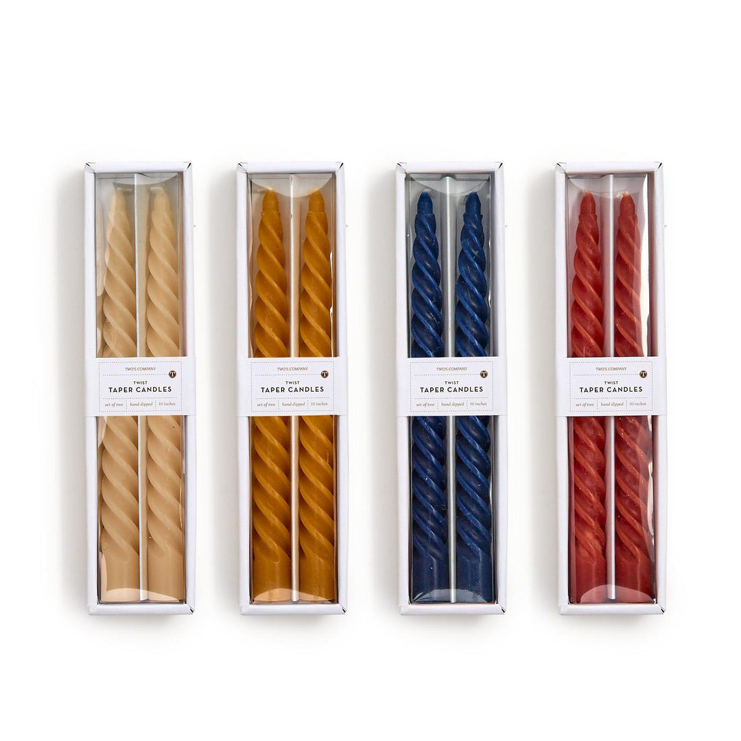 Four sets of striped candles in different colors packaging on a white background