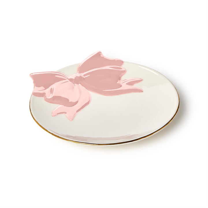 Decorative plate with a pink bow on a white background