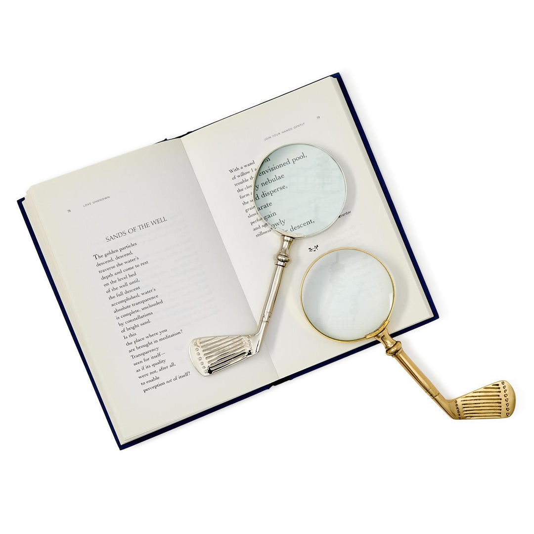 Two magnifying glasses on an open book with a white background