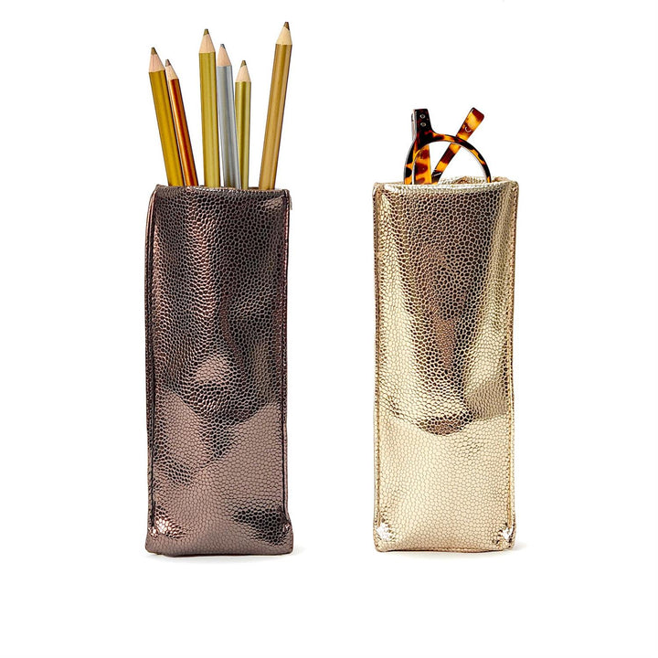 Two metallic pencil holders with pencils on a white background