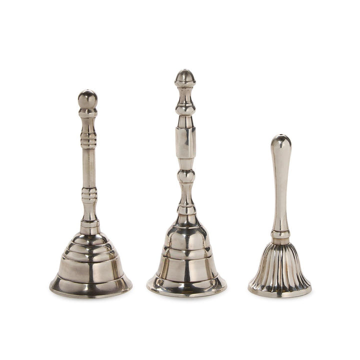 Three silver hand bells of different sizes on a white background