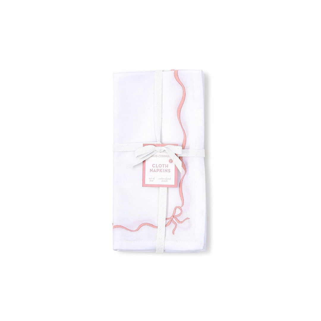 White cloth napkins with pink designs and text on a white background