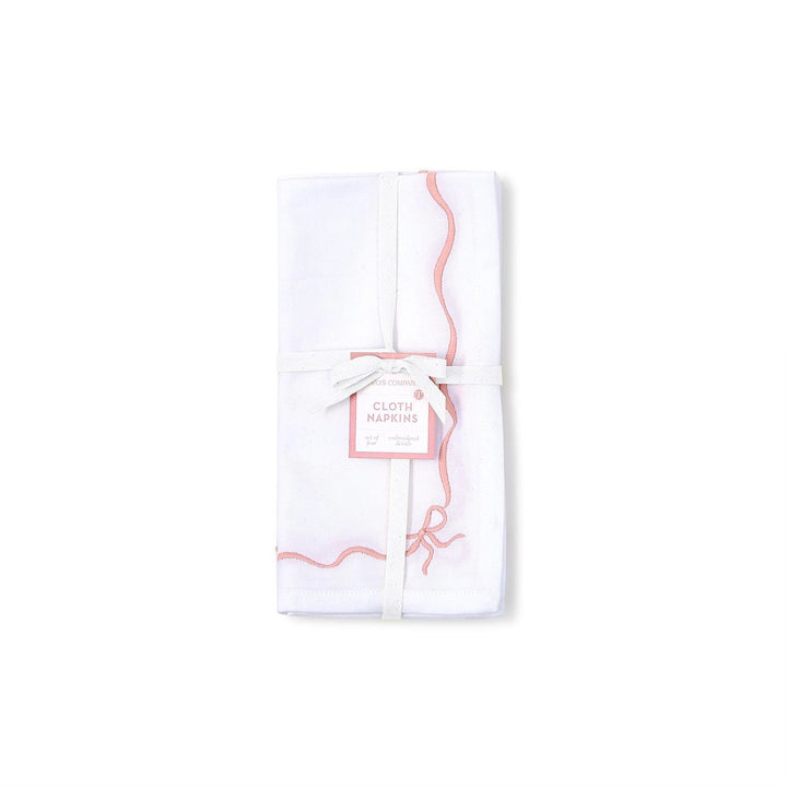 White cloth napkins with pink designs and text on a white background