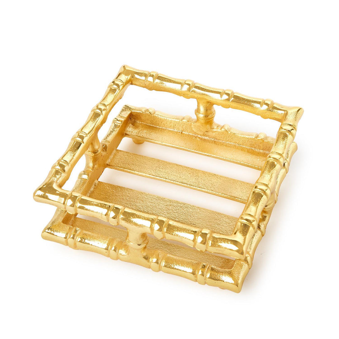 Gold bamboo-style coaster set on a white background