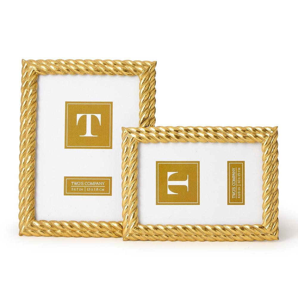 Two gold picture frames with decorative designs on a white background