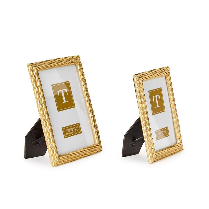 Two gold picture frames with a white center on a white background