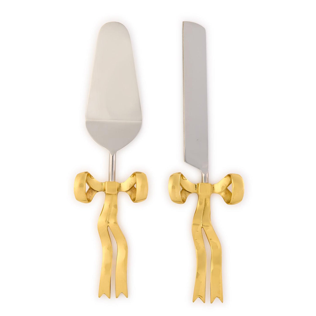 Set of cake server and knife with gold bow accents on a white background
