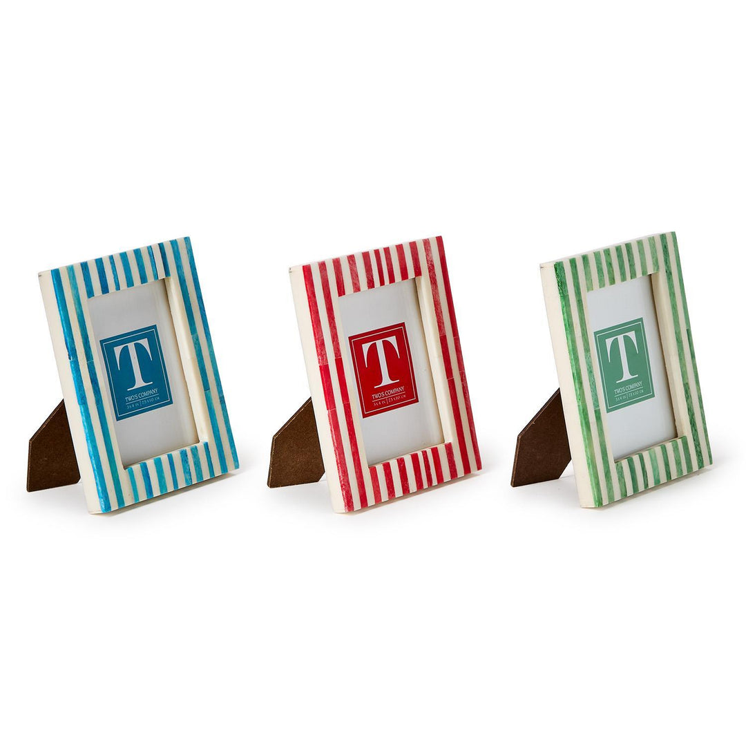 Three small photo frames with striped designs on a white background