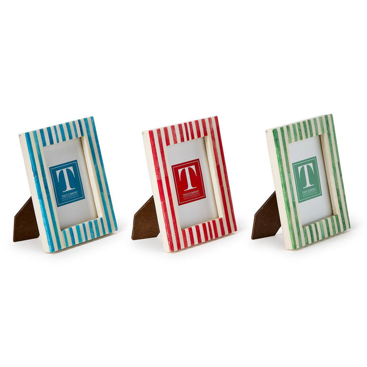 Three small photo frames with striped designs on a white background