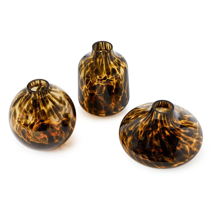 Three tortoiseshell patterned glass vases on a white background