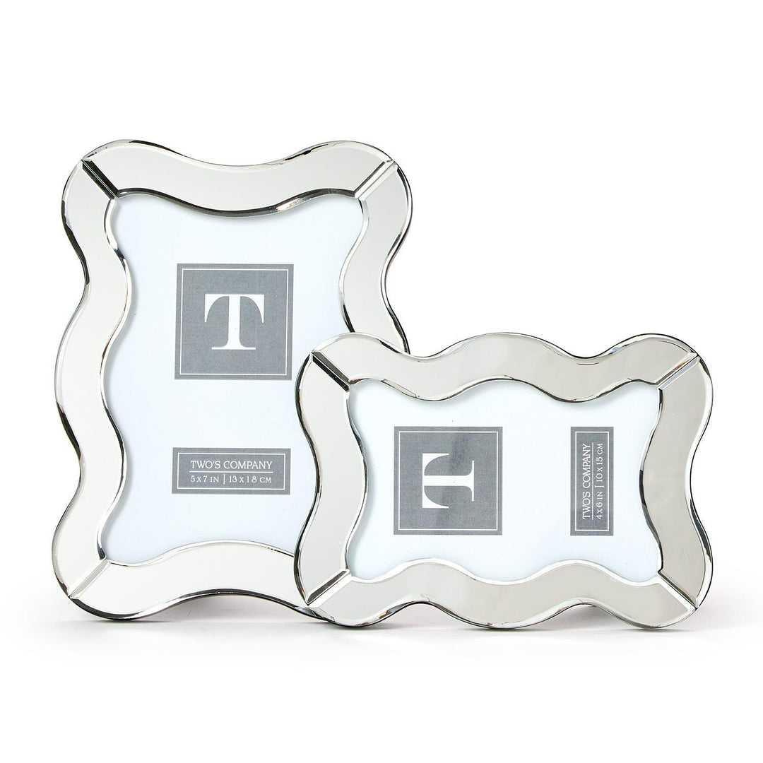 Two silver picture frames with decorative edges on a white background