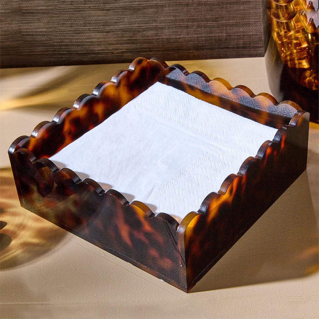Tortoiseshell-patterned tray with a white napkin on a beige surface
