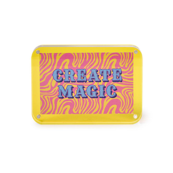 Rectangular sign with pink and yellow zebra pattern and 'CREATE MAGIC' text on a white background