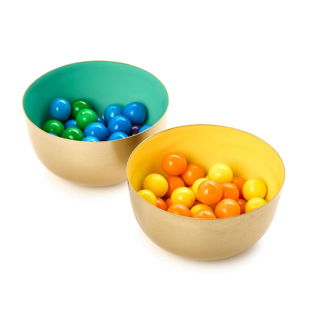 Two colorful bowls filled with small balls on a white background