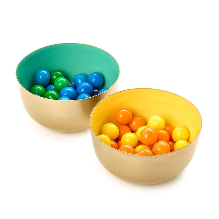 Two colorful bowls filled with small balls on a white background