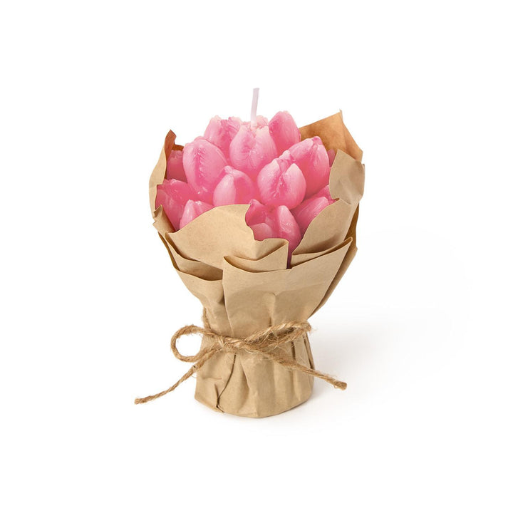 Pink candle shaped like a bouquet wrapped in brown paper on a white background