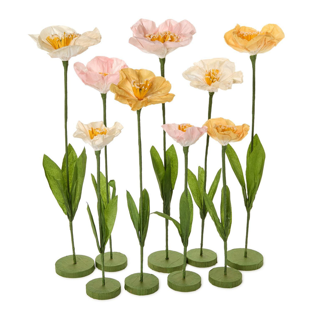 Set of artificial tulips in pink, orange, and white on green stems with round bases.