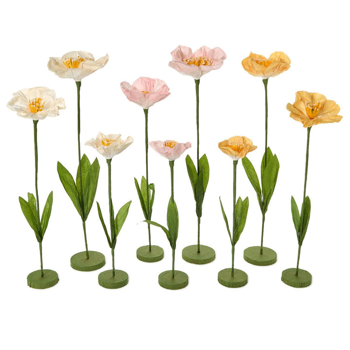 Set of artificial flowers in various colors on a white background