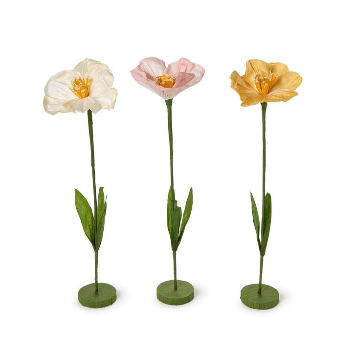 Three artificial flowers in white, pink, and yellow on a white background