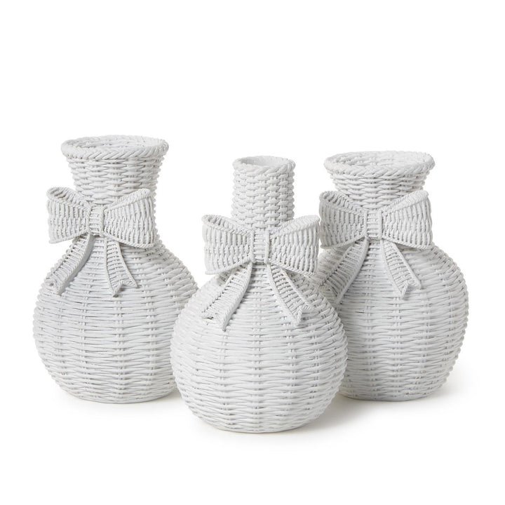 Three woven vases with bow accents on a white background