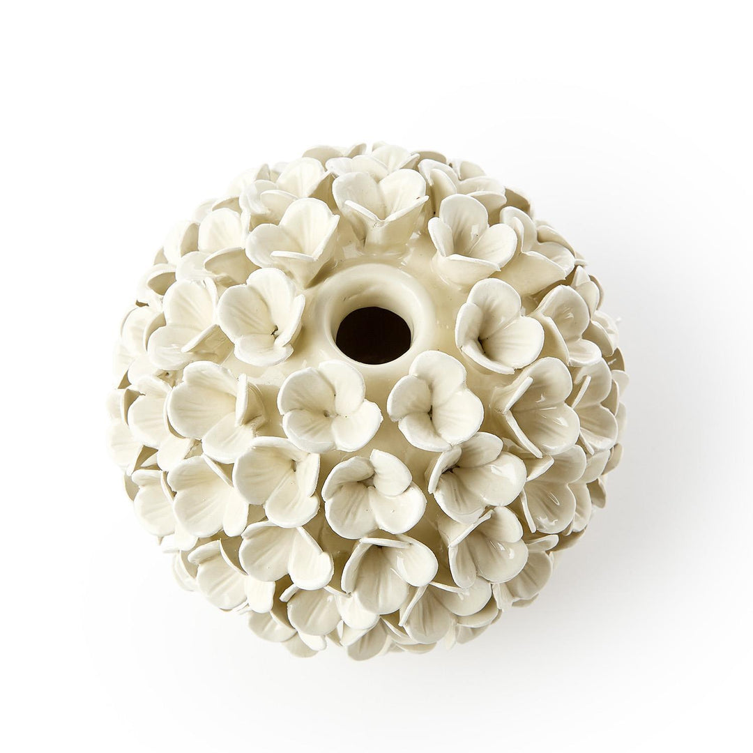White ceramic ball with floral patterns on a white background