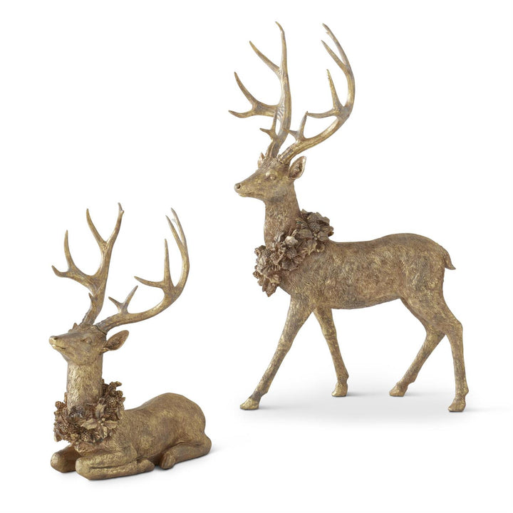 Two decorative deer statues with intricate antlers on a white background