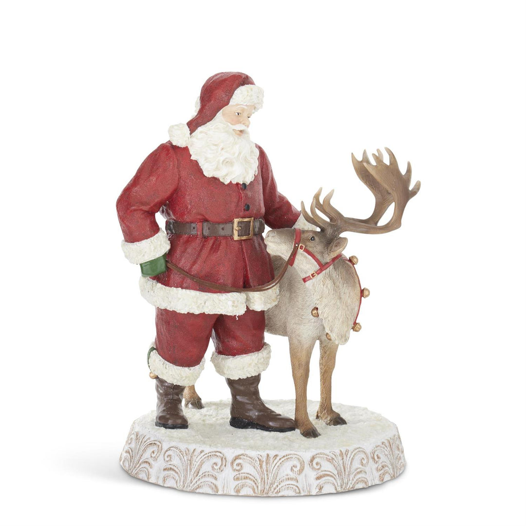 Figurine of Santa Claus with a reindeer on a decorative base