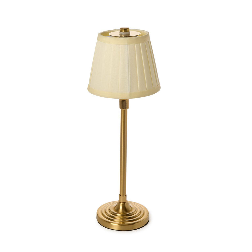 Table lamp with a pleated beige shade on a white background
