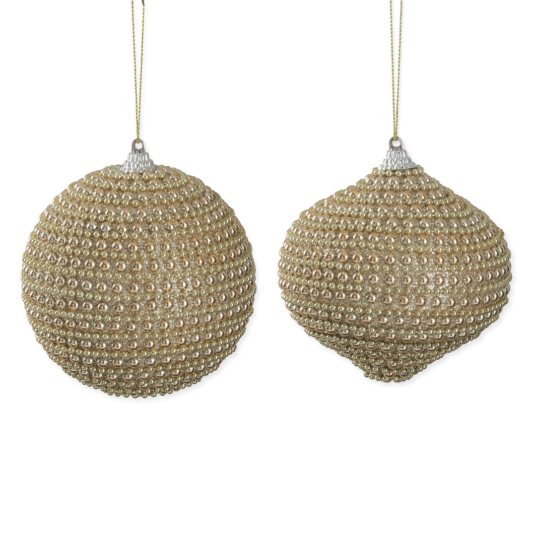 Two gold beaded Christmas ornaments on a white background