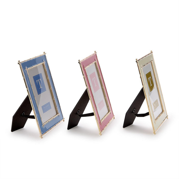Three small photo frames with stands on a white background