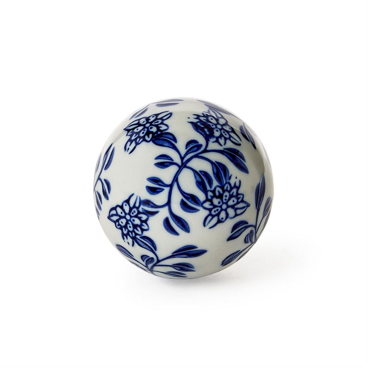 White ceramic ball with blue floral patterns on a white background