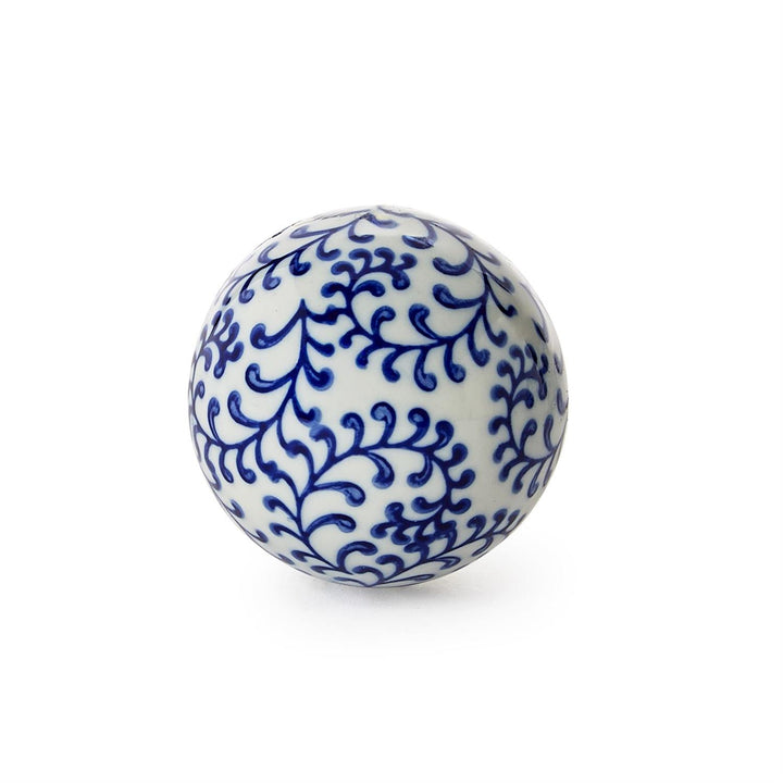 Blue and white ceramic ball with intricate patterns on a white background