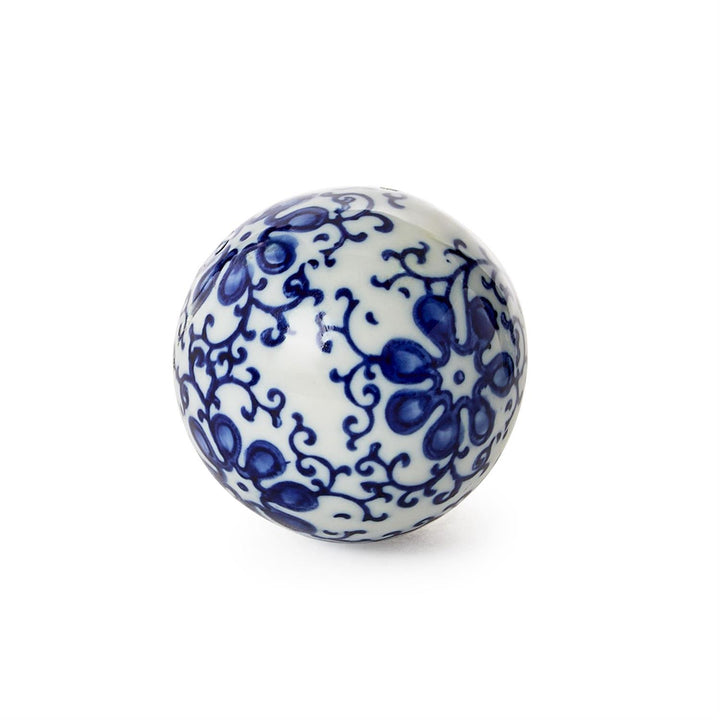 White ceramic ball with blue floral patterns on a white background