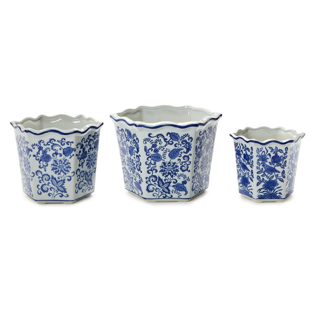 Three ceramic pots with blue floral patterns on a white background