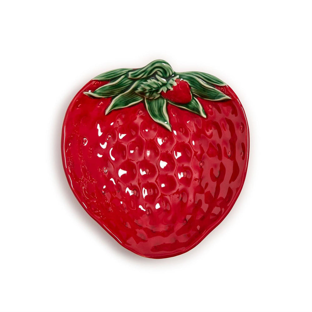 Red strawberry-shaped dish with green leaves on a white background