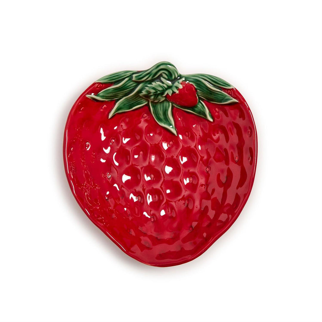 Red strawberry-shaped dish with green leaves on a white background