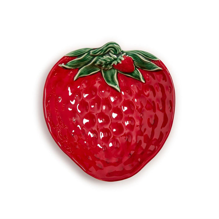 Red strawberry-shaped dish with green leaves on a white background