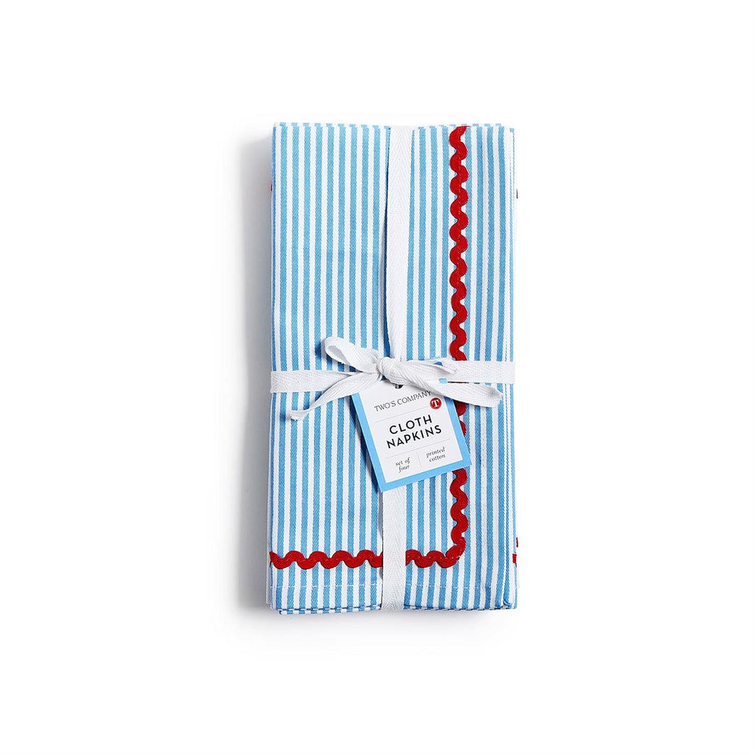 Pack of blue and white striped cloth napkins with red trim on a white background