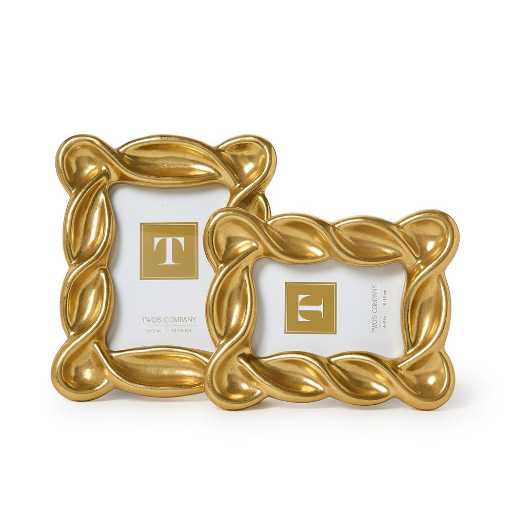 Two gold picture frames with decorative designs on a white background