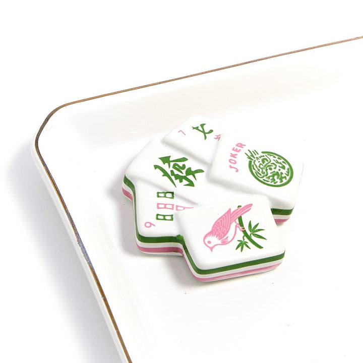 Set of Mahjong tiles with decorative designs on a white surface