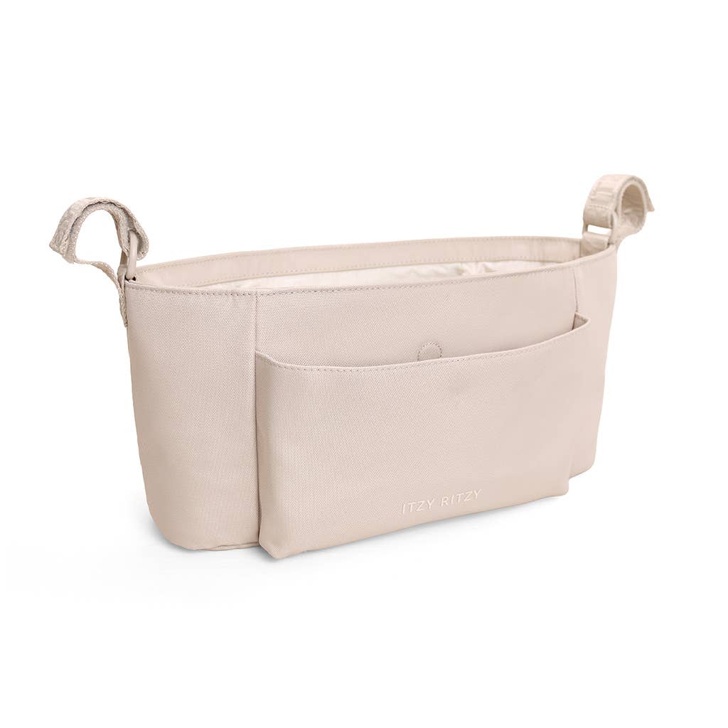 A light beige baby diaper bag organizer insert with two top handles and a front slip pocket, shown on a clean white background.