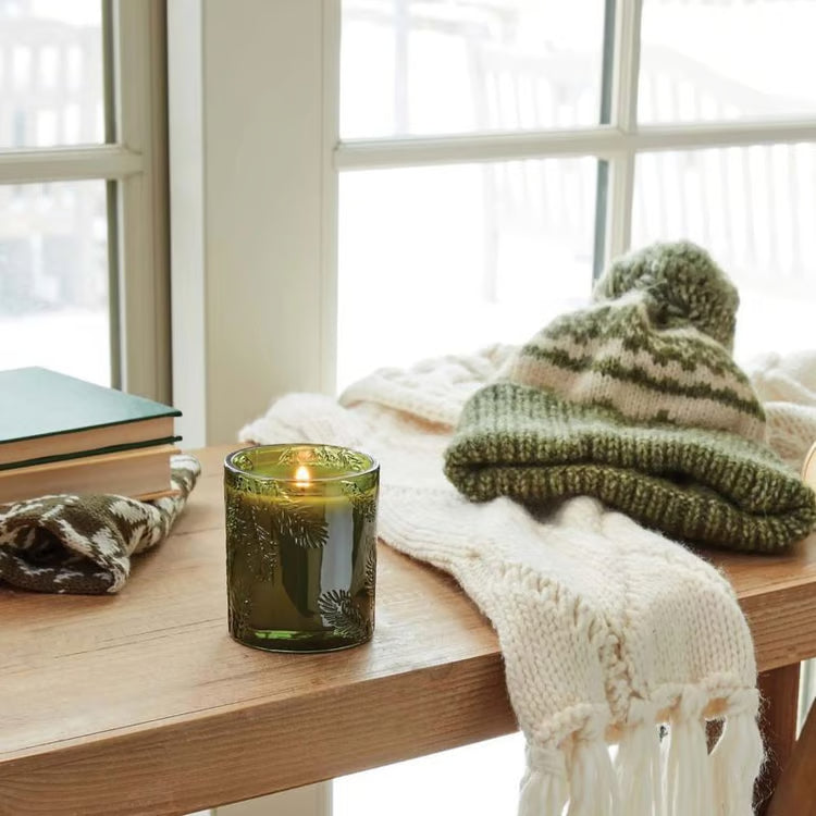 Frasier Fir green glass candle shown with coordinating holiday packaging