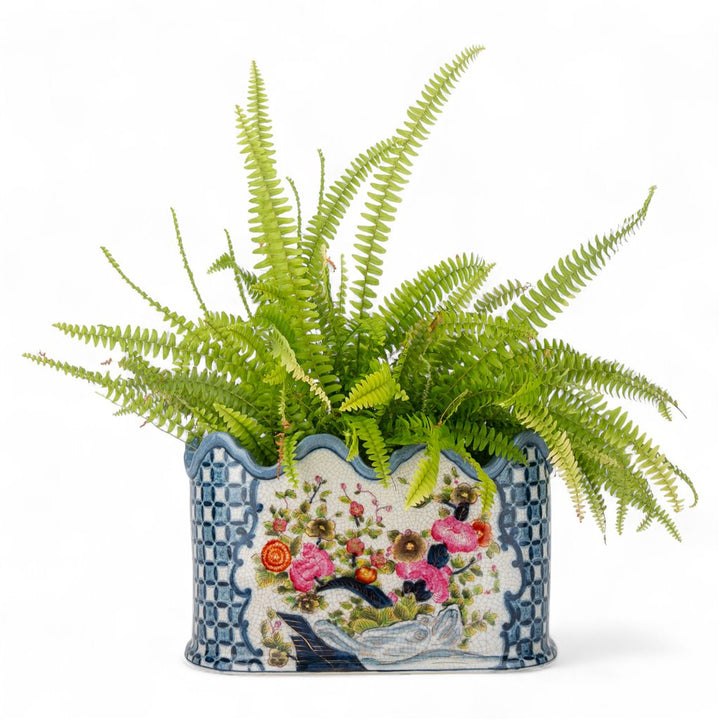 Decorative plant pot with a floral design on a white background